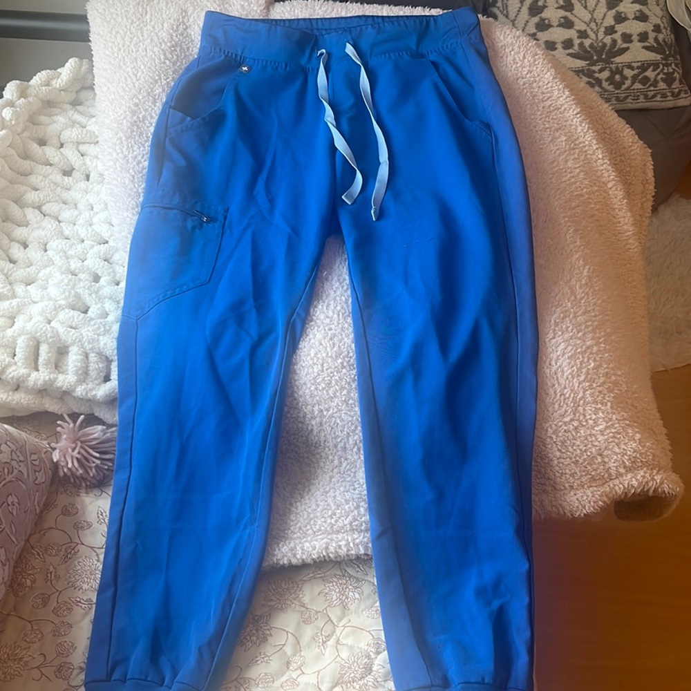Figs jogger bottoms with some wear and tear